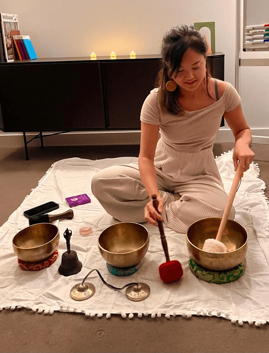 Vivien playing Himalayan singing bowls at a sound healing session