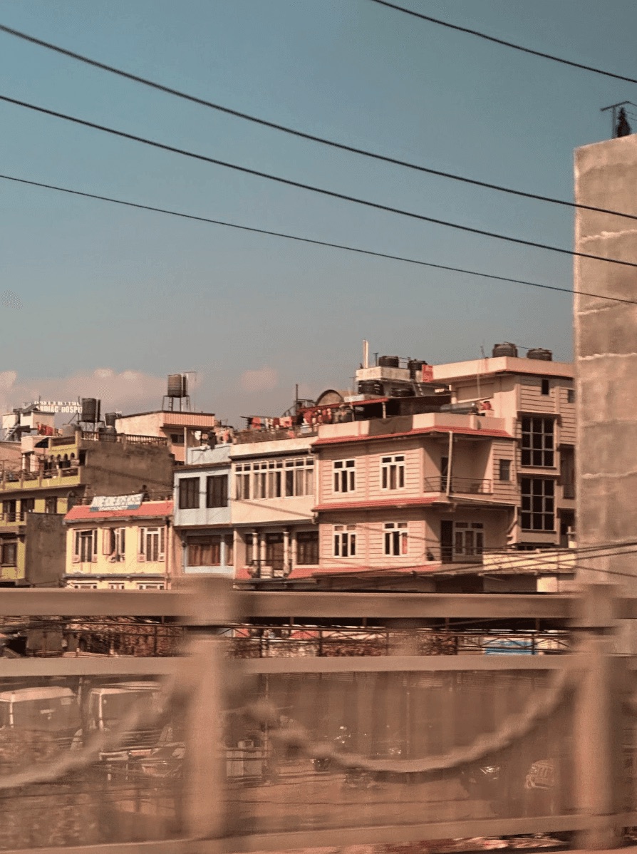 Pink buildings viewed through a window