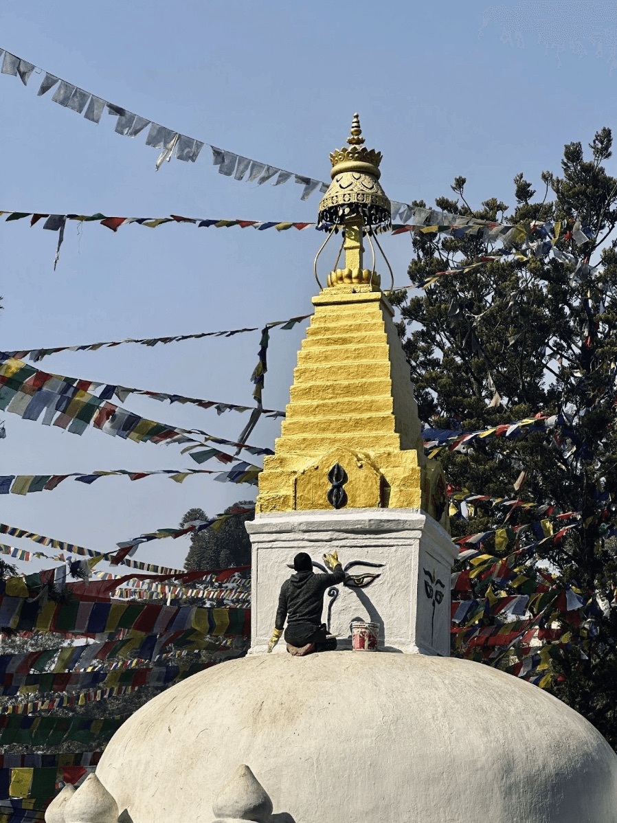 Golden stupa spire with prayer flags