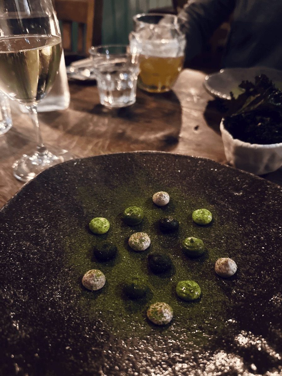 Glasses of champagne and a plate of dark chocolates on a table