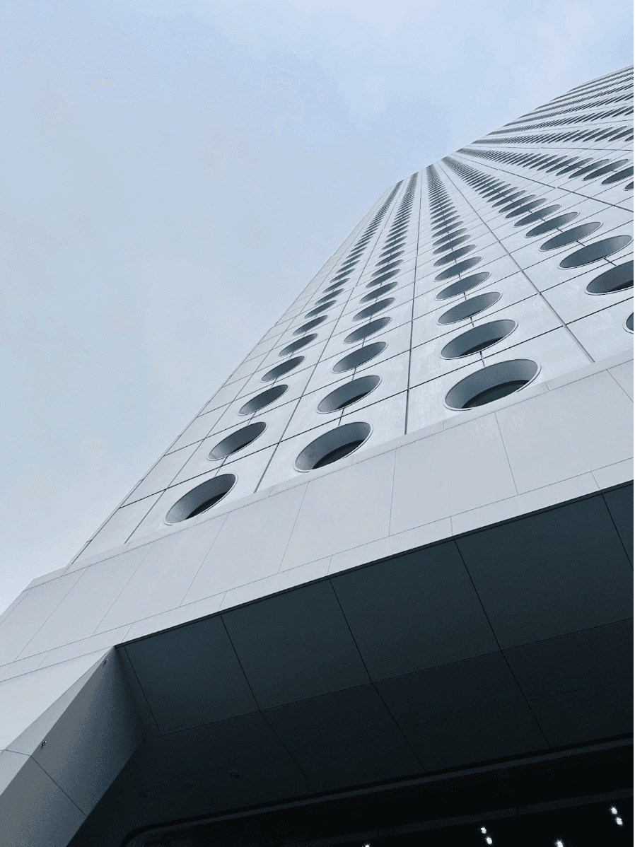 Upward view of a modern building facade with circular windows